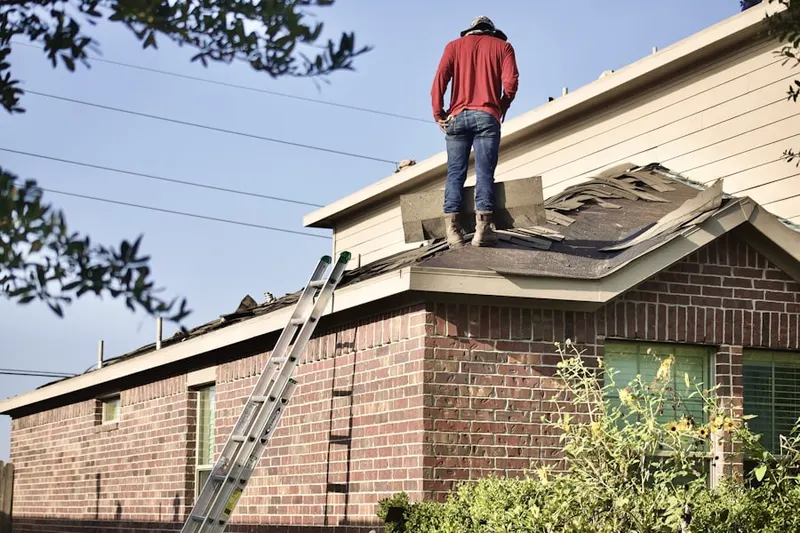 Professional roofer working on a residential roof in Marlin
